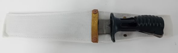 An SA80 bayonet in a white canvas scabbard.