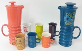 A large collection of mainly Carltonware coffee cups and pots of various bright colours,
