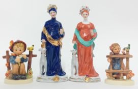 A pair of porcelain female figures with whippet dogs, together with two Goebel figurines, and a