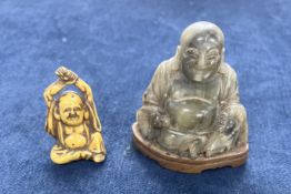 An agate figure of Budhai, the corpulent god of fortune carved seated wearing long robes open to