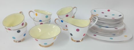 A Newtown porcelain tea service decorated with polka dots, cream interior with 22ct gilt rim,