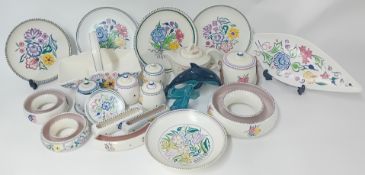 A large collection of Poole pottery, to include plates, pots, letter holders, side plates, a basket,