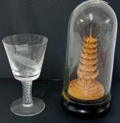 A commemorative Queen Mary Ocean Liner wine glass with air twist base, together with a model