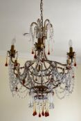 Three large modern chandeliers, to include one with beaded strings and red glass drops (some