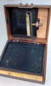 An early 20th century wooden printing box, to include roller, ink tray, and paper sheets, with a