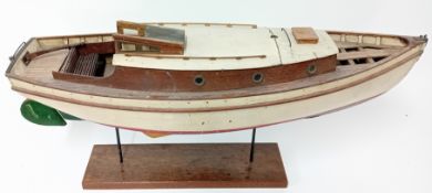 A teak and mahogany model yacht on a stand, the roof lifting off to reveal fitted interior, length