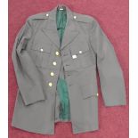 A US Army Uniform jacket, of green wool and polyester, eagle detail to gilt buttons.