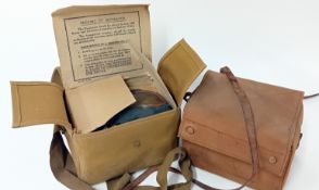 Two WWII civilian gas masks, in card inner boxes and canvas case. (2)