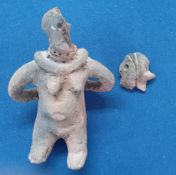 A clay fertility figure, in pre-Columbian style, in the form of a woman carrying a pot on her