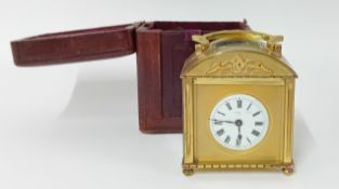 A late 19th century brass carriage clock, cased, with key, roman enamel dial, indistinct maker