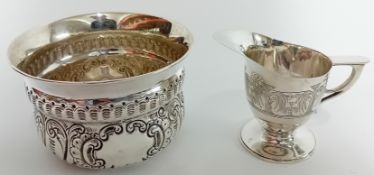 An early 20th century sugar bowl and milk jug (not a pair), hallmarked Birmingham 1903/1912, with