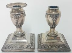 A pair of Victorian silver candlesticks, hallmarked Sheffield 1891, height 11cm (one missing rim),