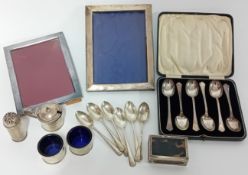 A collection of silver pieces, to include teaspoons, frames, matchbox case, cruet pieces, etc.