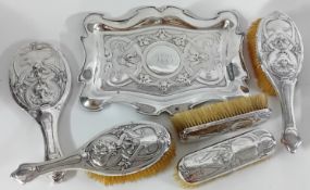 A silver dressing table set, to include two brushes, mirror, tray, and two clothes brushes,