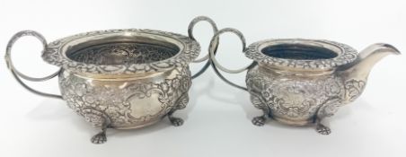 An Irish George IV silver milk jug and sugar bowl, embossed floral decoration, hallmarked Dublin