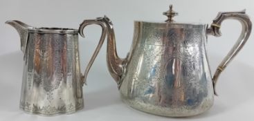 A Victorian silver teapot and milk jug, of engraved foliate design, ivory insulators to teapot,