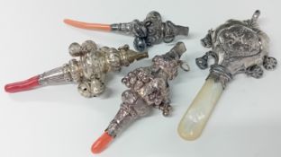 Three silver mounted coral rattles with bells and whistle top, together with a silver mounted mother