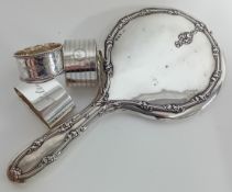 An early 20th century silver hand mirror, hallmarked Birmingham 1911, together with three silver