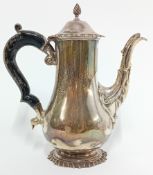 An early 20th century silver coffee pot by Mappin & Webb, with decorated spout and finial, wooden