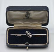 A three stone diamond bar brooch, assessed as 18ct gold and platinum, total diamond weight 0.72ct,
