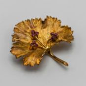 A gold and ruby set 'leaf' design brooch, set in 18ct yellow gold, total weight approx 11.3g.