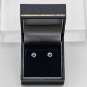 A pair of diamond stud earrings, set in 18ct white gold, each approx 0.50/0.70ct. Item 7 on your