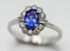 A diamond and tanzanite cluster ring, set in 18ct white gold, size M.