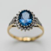 A diamond and blue topaz dress ring, set in 9ct yellow gold, size N, approx 2.9g.