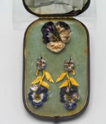 An enamel suite of 'Flower' jewellery to include earrings and brooch (faults), boxed.