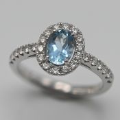 A diamond and aquamarine cluster ring, with further diamonds to the shoulders, size L, approx 3.5g.