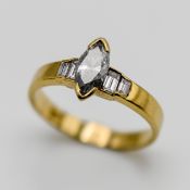 A marquise diamond set ring with further emerald cut diamonds to the shoulders, set in 18ct yellow