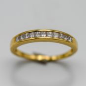 A diamond half eternity ring, set in yellow gold (not hallmarked), size L/M, approx 2.4g.