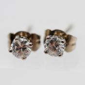 A pair of single stone diamond earrings, set in 18ct white gold.