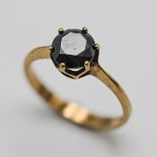 A rare black diamond solitaire ring, set in 9ct yellow gold, size N.