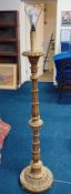 A carved wood and gilded standard lamp.