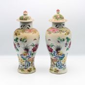 A pair of ‘famille-rose’ baluster vases and matched covers, 19th century, each of baluster form