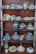 A large quantity of mainly blue and white and willow pattern tea and dinner service pieces, jugs,