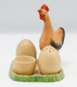 A Clarice Cliff novelty cruet set, in the form of a chicken and eggs, to include salt and pepper