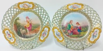 A pair of Minton or Derby ribbon plates, with pastoral scenes painted by James Rouse of a