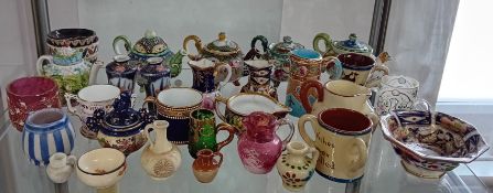 A collection of miniature teapots, jugs, bowls, mugs, etc, to include cranberry glass pieces, etc.