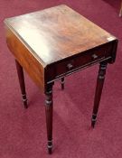 An early 19th century mahogany drop flap work table on ring turned legs, fitted with one real and