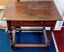 An 18th century oak side table fitted with a single drawer, on turned legs and stretchers. Width