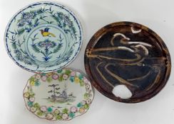A tin-glazed earthenware bowl of painted floral decoration, together with a slipware plate inscribed