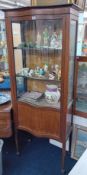A mahogany and inlaid single door display cabinet with serpentine front. Width 70cm.