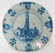 An 18th century Bristol Delftware plate, c.1720, decorated with a smouldering bottle kiln,