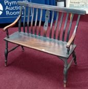 A country seat, two seater with lathe back supports, scroll arms and turned legs. Width 105cm.