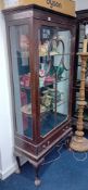 An early 20th century mahogany display cabinet fitted with one single glazed door over a single