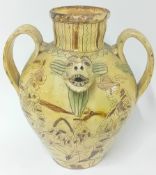 A large slipware pouring vessel, the spout in the form of a grotesque cow, double handled, decorated