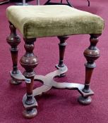 An early 20th century walnut stool with turned legs, cross stretchers, bun feet and upholstered