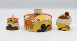 Three Clarice Cliff sugar or preserve pots in 'House and Bridge' pattern. (3)